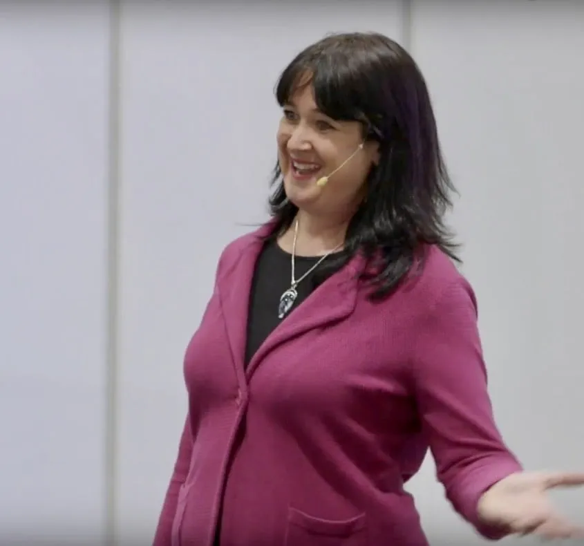 Mindy wearing a headset on stage
