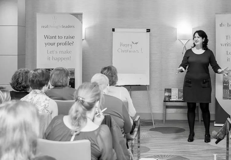 Mindy standing in front of a group of people on a workshop